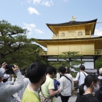Tourists visit Kinkakuji temple in Kyoto on May 3 during the Golden Week holidays. | BLOOMBERG