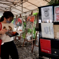A woman reads a book on martial law under the late dictator Ferdinand Marcos at a store in Quezon City, Philippines, on May 21.  | REUTERS