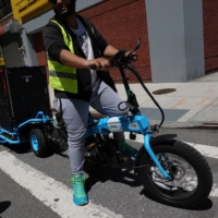 A worker rides an URB-E delivery bicycle in New York on May 9. | REUTERS