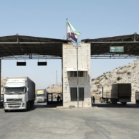 Trucks drive at the Bab al-Hawa crossing at the Syrian-Turkish border, in Syria\'s Idlib governorate, last June. | REUTERS