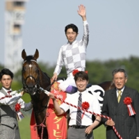 Jockey Yutaka Take celebrates atop Do Deuce after winning the Japanese Derby at Tokyo Racecourse on Sunday. | KYODO