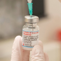 A health care worker prepares to administer a COVID-19 booster shot at a vaccination center in Zurich in November.  | REUTERS