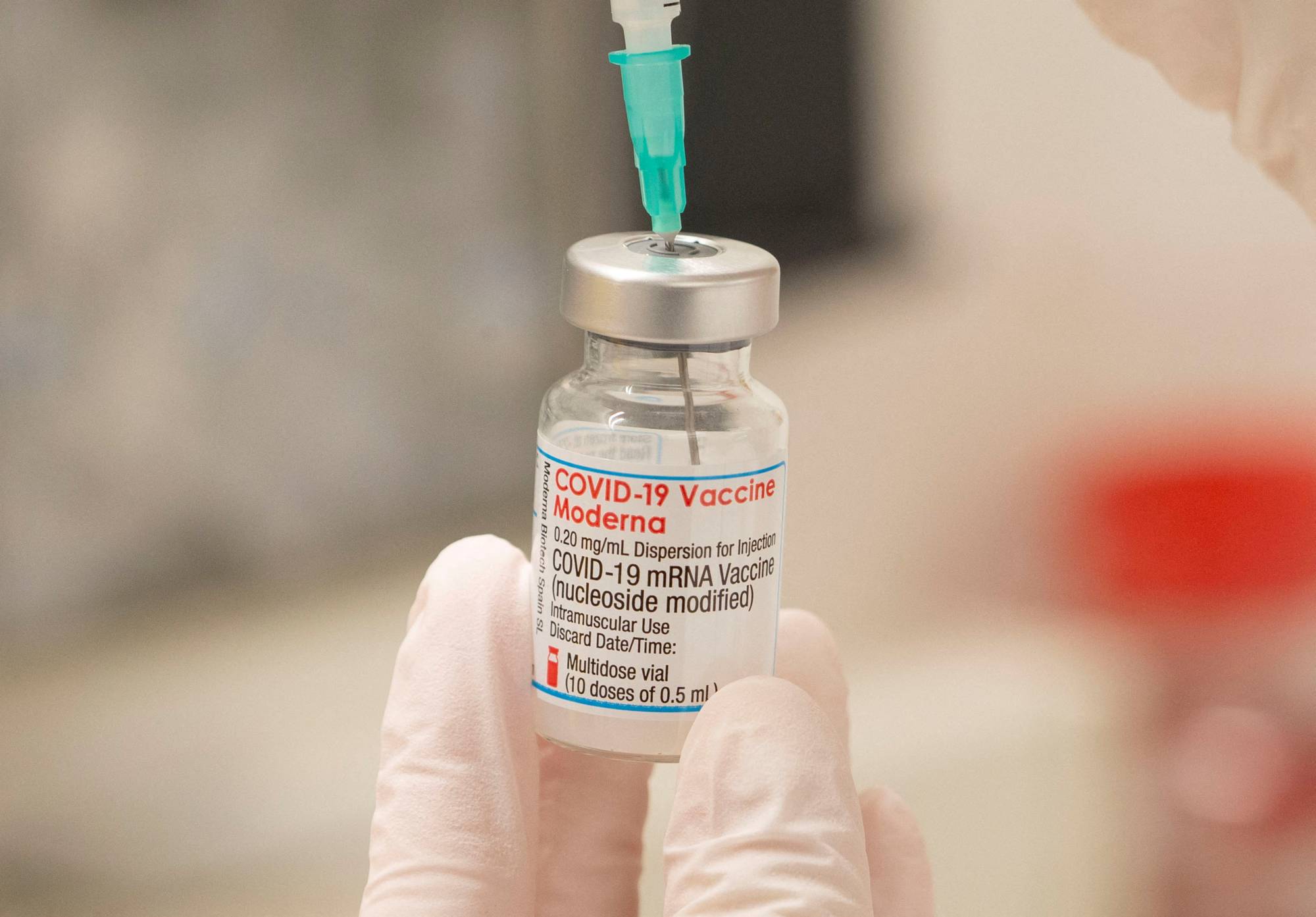 A health care worker prepares to administer a COVID-19 booster shot at a vaccination center in Zurich in November.  | REUTERS