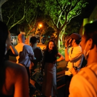 People chat and drink on a street in Shanghai on Tuesday, as the city prepared to end a COVID-19 lockdown. | REUTERS