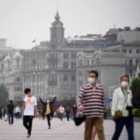 People visit the Bund, after the lockdown placed to curb the COVID-19 outbreak was lifted in Shanghai on Wednesday. | REUTERS