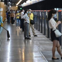 People wait for a train at a subway station in the Jing\'an district of Shanghai on Wednesday, after the end of a COVID-19 lockdown that kept the city closed for two months with heavy-handed restrictions. | AFP-JIJI