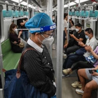 People travel on a subway in the Jing\'an district of Shanghai on Wednesday, after the end of a COVID-19 lockdown that kept the city under heavy-handed restrictions for two months. | AFP-JIJI