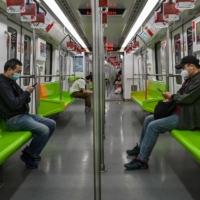 People travel on a subway in the Jing\'an district of Shanghai on Wednesday, after the end of a COVID-19 lockdown that kept the city under heavy-handed restrictions for two months. | AFP-JIJI