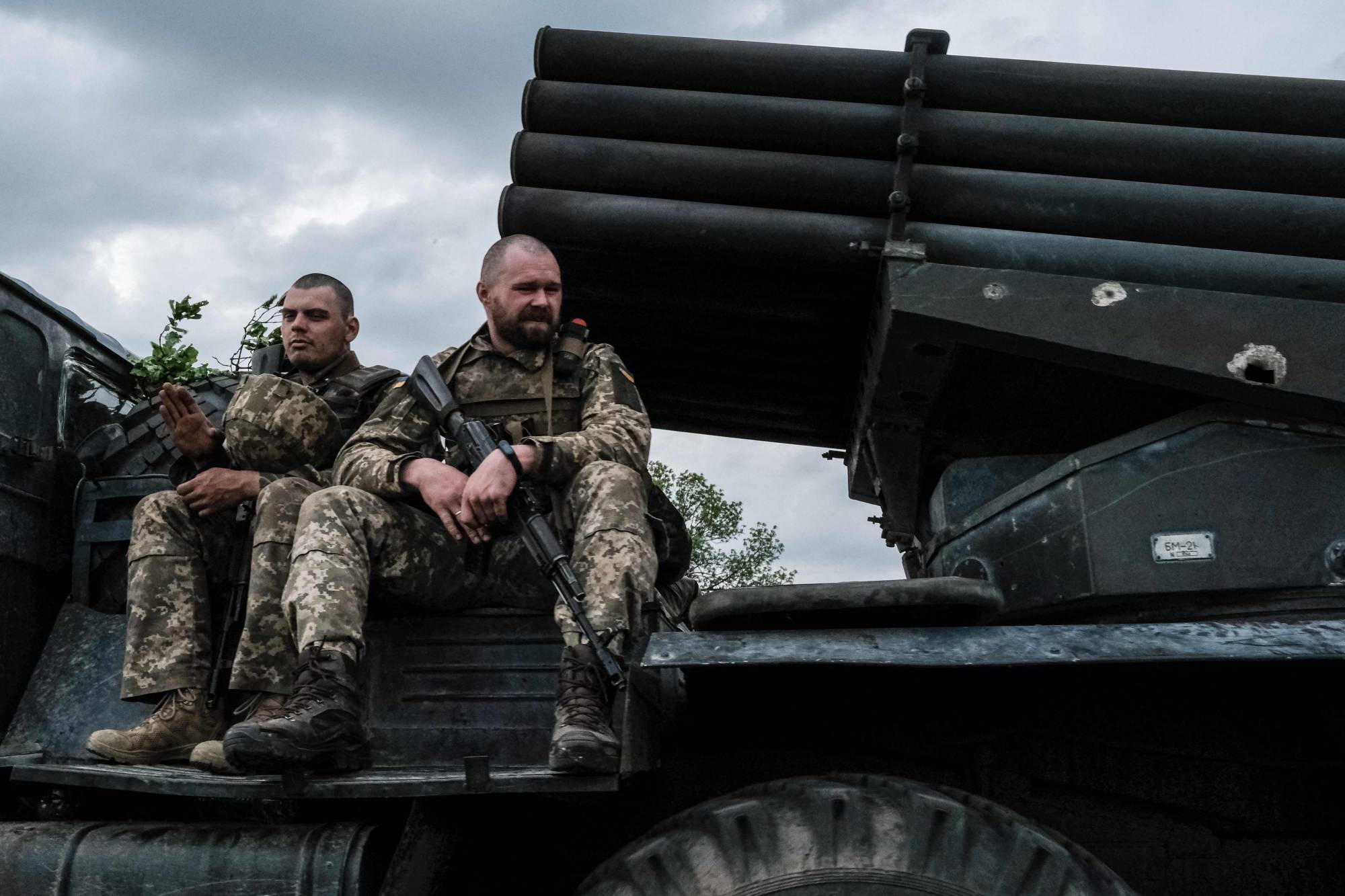 Ukrainian soldiers sit atop a moving truck-mounted multiple rocket launcher near Lysychansk, eastern Ukraine on May 13. | AFP-JIJI