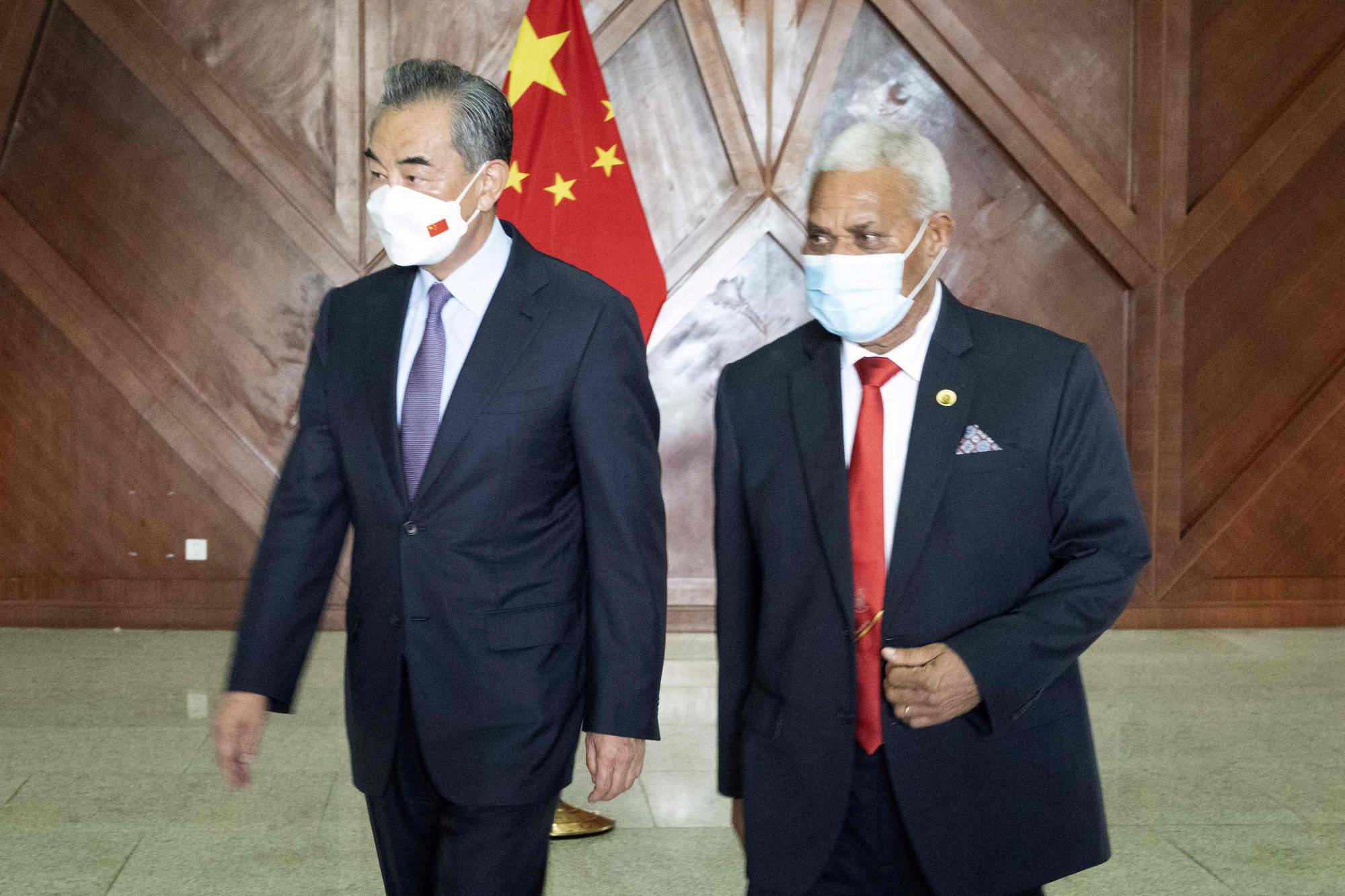 Chinese Foreign Minister Wang Yi (left) and Vanuatu's Prime Minister Bob Loughman Weibur after a media event in Port Vila, Vanuatu, on Wednesday. On Monday, Wang aimed to sign a sweeping regional deal in the South Pacific to entrench Beijing’s influence. | AFP-JIJI