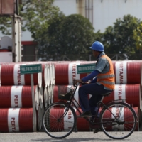 Barrels of petroleum products at a state-owned Pertamina fuel depot in Jakarta in 2014. Over the past three years, East and Southeast Asia have felt the pinch of reduced green energy funding the most, with the organizations warning the pandemic could cause further cuts. | REUTERS