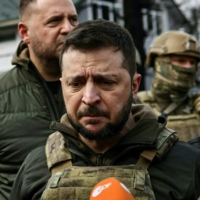 Ukainian President Volodymyr Zelenskyy (center) in Bucha, Ukraine, on April 4. France, Germany and Italy, in particular, have begun to call for ceasefire talks that, if concluded today, would leave as much as 20% of Ukrainian territory under Russian control. | AFP-JIJI