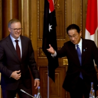 Prime Minister Fumio Kishida greets his Australian counterpart, Anthony Albanese (left), during the \"Quad” summit in Tokyo on May 24.  | POOL / VIA REUTERS