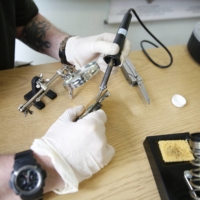 An investigator desolders a component from a Russian surveillance drone collected by security officials working in Ukraine. The tools that Russian forces are using to wage war in Ukraine are often powered by American innovation.  | CONFLICT ARMAMENT RESEARCH / VIA THE NEW YORK TIMES