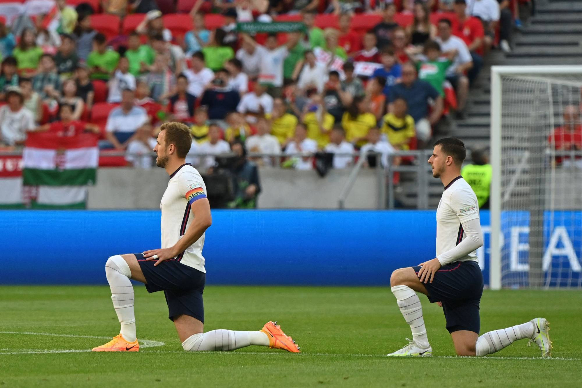 England forward Harry Kane (left) and midfielder Mason Mount take a knee prior to their UEFA Nations League match against Hungary in Budapest on Saturday. | AFP-JIJI