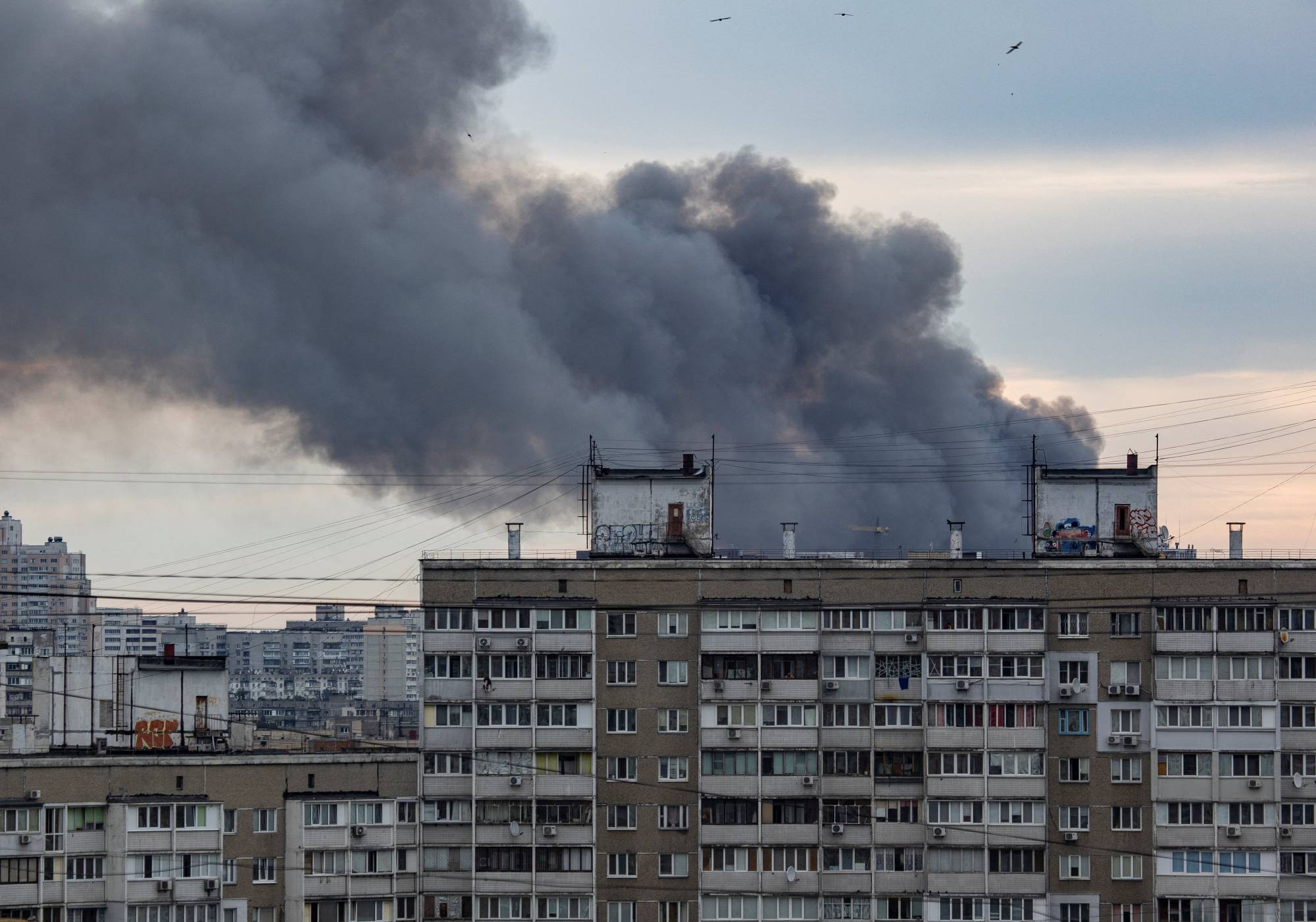 Smoke from a Russian missile strike rises over Kyiv on Sunday.  | REUTERS