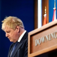 British Prime Minister Boris Johnson listens to reporters questions during a news conference inside the No. 10 Downing St. briefing room in London on March 7. Johnson held off a challenge by rebels to remain leader of the governing Conservative Party on Monday. | POOL / VIA AFP-JIJI
