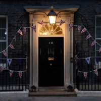 The entrance to No. 10 Downing St. is illuminated Monday evening. Johnson\'s hollow victory over the rebels leaves the British prime minister weakened and exposed the divisions that may ultimately sink his premiership. | AFP-JIJI
