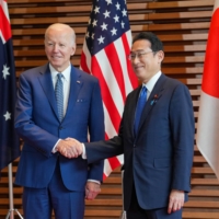 Kishida and U.S. President Joe Biden pose for a photo ahead of a \"Quad\" leaders meeting in Tokyo on May 24. | BLOOMBERG