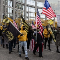 Members of the Proud Boys march with demonstrators during a protest against a COVID-19 vaccine mandate as part of a \"Global Freedom Movement\" in New York on Nov. 20. | AFP-JIJI