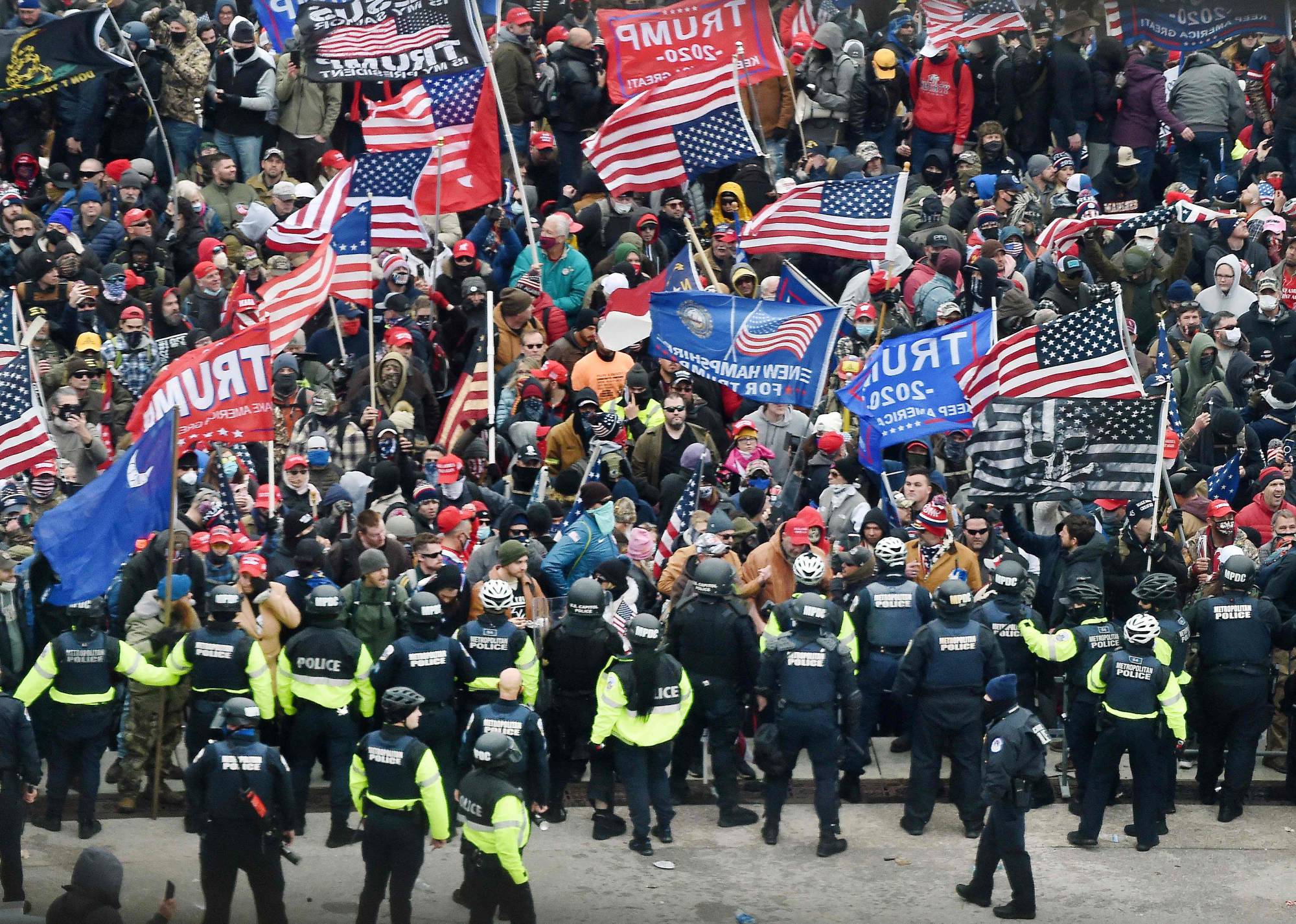 Trump supporters clash with police and security forces as they storm the U.S. Capitol in Washington on Jan. 6, 2021. A former leader of the Proud Boys and four other members of the far-right group were indicted on sedition charges on Monday in connection with the Jan. 6 assault on the U.S. Capitol. | AFP-JIJI