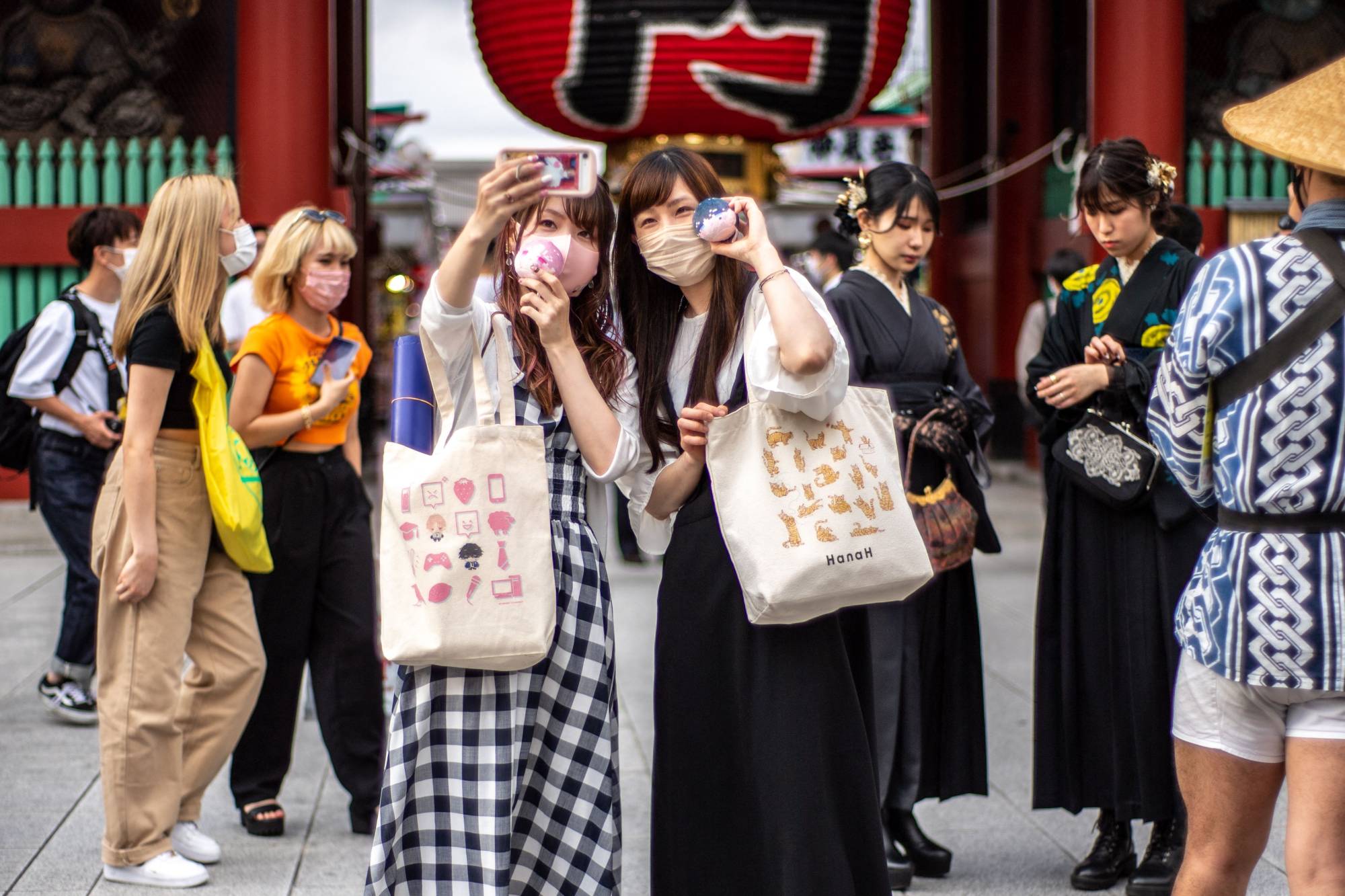 Visitors at Sensoji temple in Tokyo on May 30. Foreign tourists will be required to wear masks and purchase private medical insurance under tourism guidelines unveiled Tuesday. | AFP-JIJI