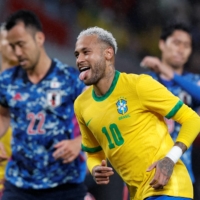 Brazil\'s Neymar (right) celebrates scoring their first goal against Japan during an international friendly against Brazil at the National Stadium in Tokyo on Monday. | REUTERS