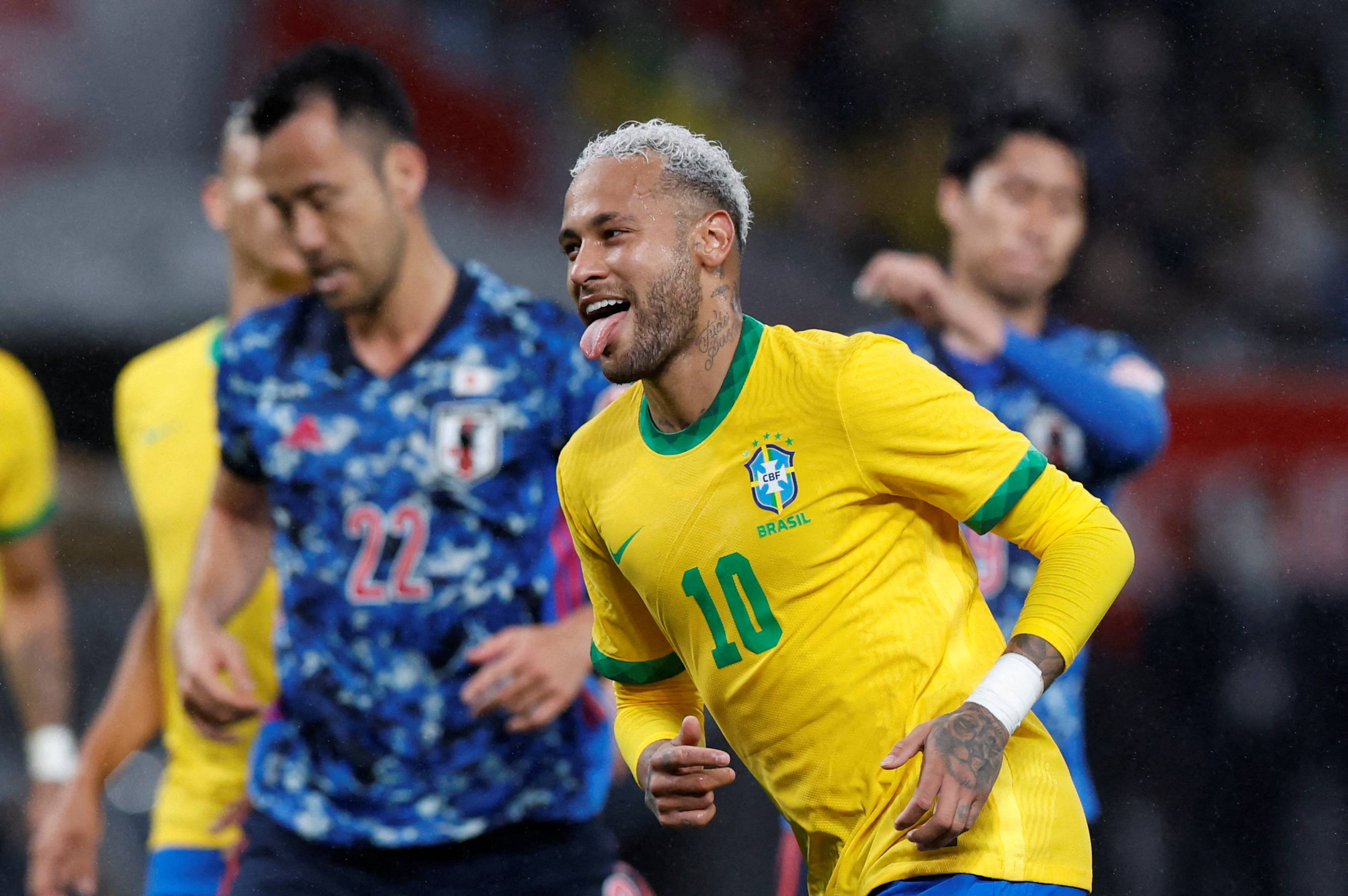 Brazil's Neymar (right) celebrates scoring their first goal against Japan during an international friendly against Brazil at the National Stadium in Tokyo on Monday. | REUTERS