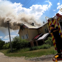 A house burns in a residential area in Kharkiv, Ukraine, following a military strike on Tuesday. | REUTERS