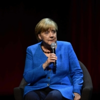 Former German Chancellor Angela Merkel speaks on stage during her first public talk since stepping down, at the Berliner Ensemble theater in Berlin on Tuesday. | AFP-JIJI