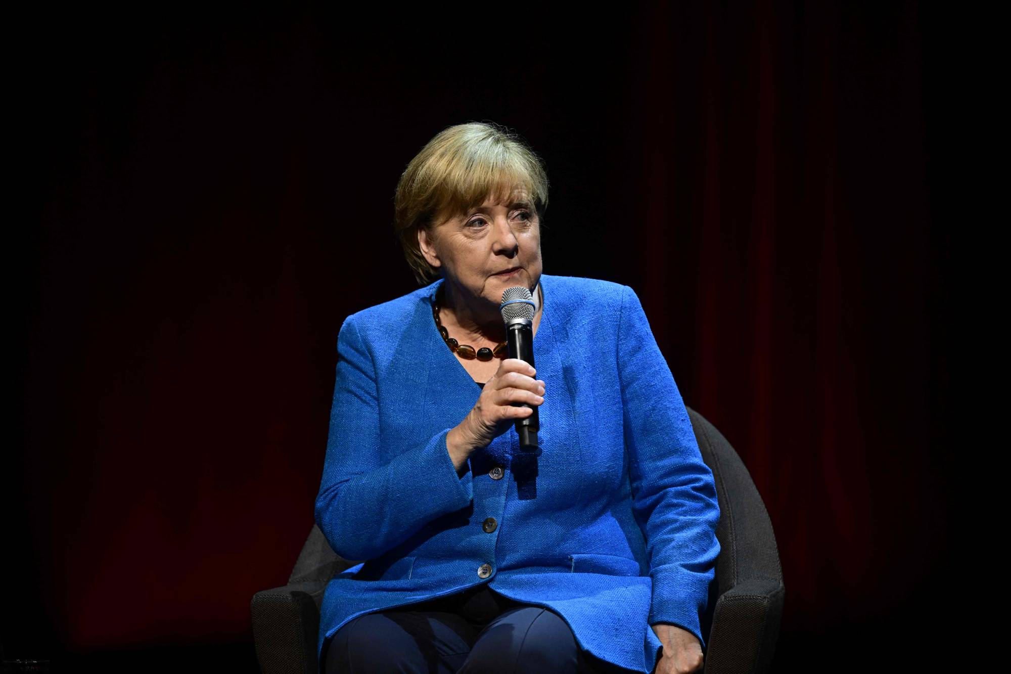 Former German Chancellor Angela Merkel speaks on stage during her first public talk since stepping down, at the Berliner Ensemble theater in Berlin on Tuesday. | AFP-JIJI