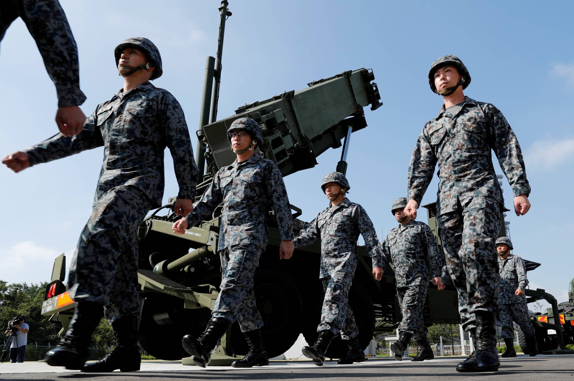 Japan Self-Defense Forces soldiers walk past a Patriot Advanced Capability-3 missile unit at the Defense Ministry in Tokyo in 2017. | REUTERS 