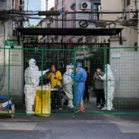 A resident gets tested for COVID-19 at a sealed area, after the lockdown placed to curb the virus outbreak was lifted in Shanghai on Wednesday. | REUTERS