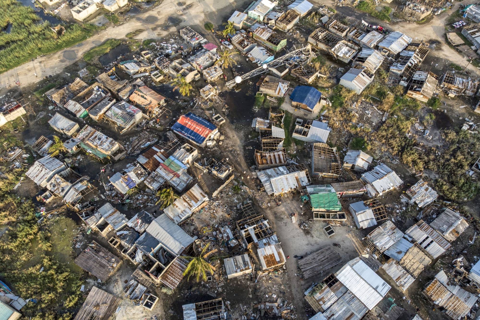 Debris and destroyed buildings from the cyclone in Beira, Mozambique, in March 2019. More than three years since Cyclone Idai devastated the fish market in the city of Beira, many are still doing business in makeshift plastic shelters that are poorly equipped and provide little respite from the hot sun. | Bloomberg