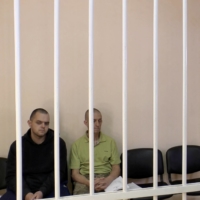 Britons Aiden Aslin, Shaun Pinner and Moroccan Brahim Saadoun captured by Russian forces during a military conflict in Ukraine, in a courtroom cage at a location given as Donetsk, Ukraine, on Wednesday. | SUPREME COURT OF DONETSK PEOPLE\'S REPUBLIC / VIA REUTERS TV 