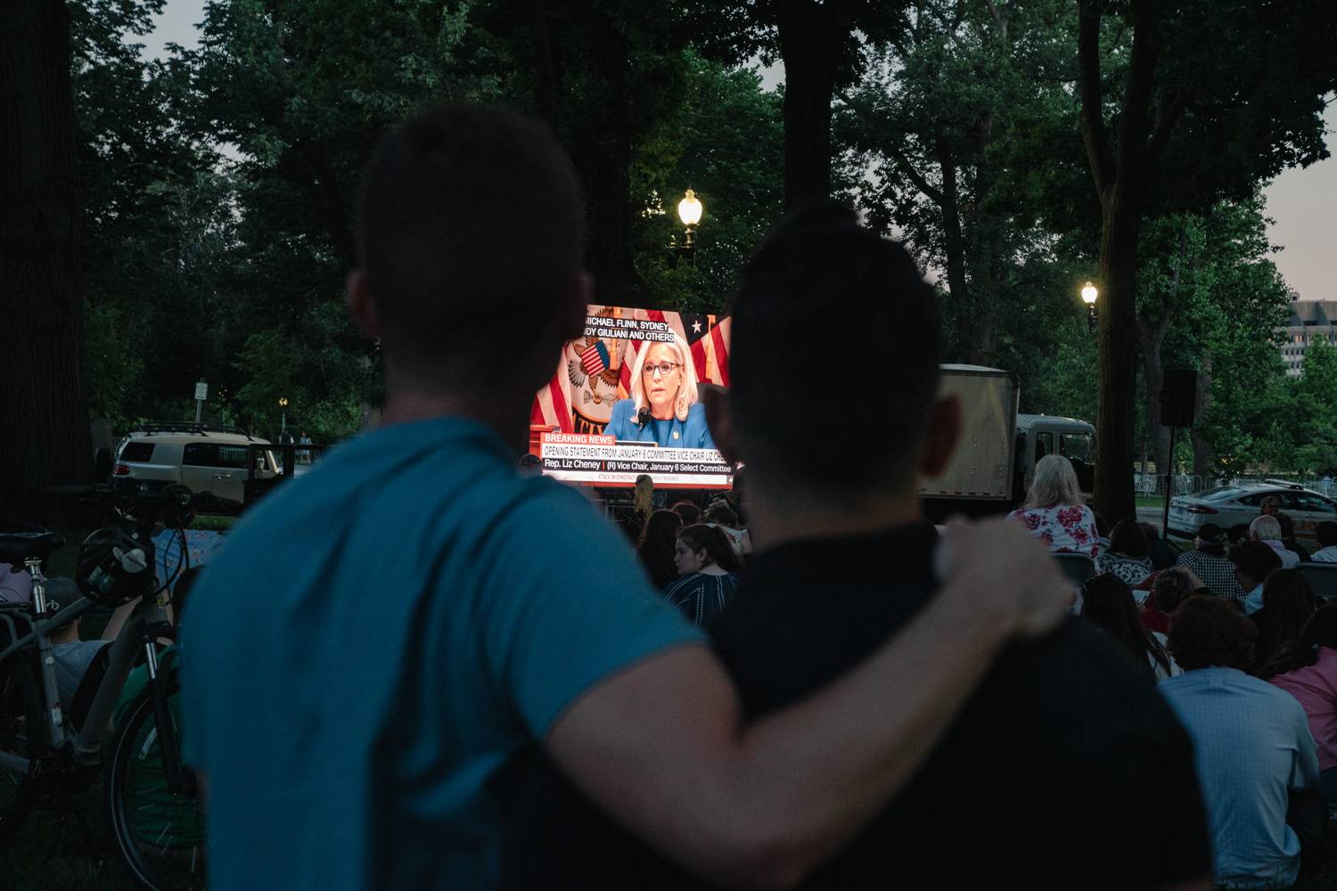 People at the Taft Memorial Carillon in Washington watch the first public hearing of the House Select Committee to Investigate the Jan. 6 Attack on the U.S. Capitol, on Thursday. | Shuran Huang / The New York Times