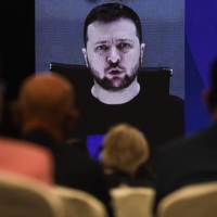 Ukraine President Volodymyr Zelenskyy addresses participants at the Shangri-La Dialogue security summit virtually via a video link in Singapore on Saturday. | AFP-JIJI
