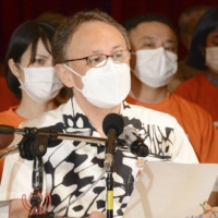 Okinawa Gov. Denny Tamaki speaks at a new conference in Naha on Saturday. | KYODO