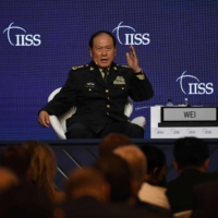 Chinese Defense Minister Wei Fenghe speaks at the Shangri-La Dialogue security forum in Singapore on Sunday. | AFP-JIJI
