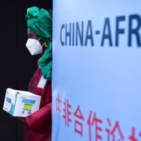 A hostess stands at the entrance of the Forum on China-Africa Cooperation in Dakar, Senegal, on Nov. 29. A survey conducted by the Ichikowitz Family Foundation found that 76% of 4,507 young Africans across 15 countries named China as a foreign power with a positive influence on their lives. | REUTERS