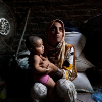 Razia, 25, and her six-month-old daughter Tamanna, sit in front of a fan to cool off during a heat wave in Jacobabad, Pakistan, on May 15. Last month, Jacobabad became the hottest city on Earth. | REUTERS
