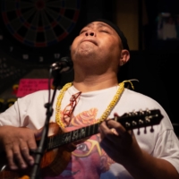 Konishiki plays the ukulele during a concert in Yokohama on June 20, 2014. | JOHN GUNNING
