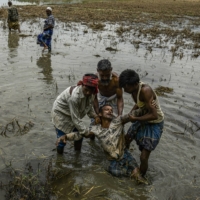 Hifjur Rehman, a third-generation farmer, collapses in a paddy field destroyed by floods in Dima Hasao, India, on June 2. Hundreds of millions of humanity\'s most vulnerable live in South Asia, where rising temperatures make it more difficult to address poverty, food security and health challenges. | ATUL LOKE / THE NEW YORK TIMES