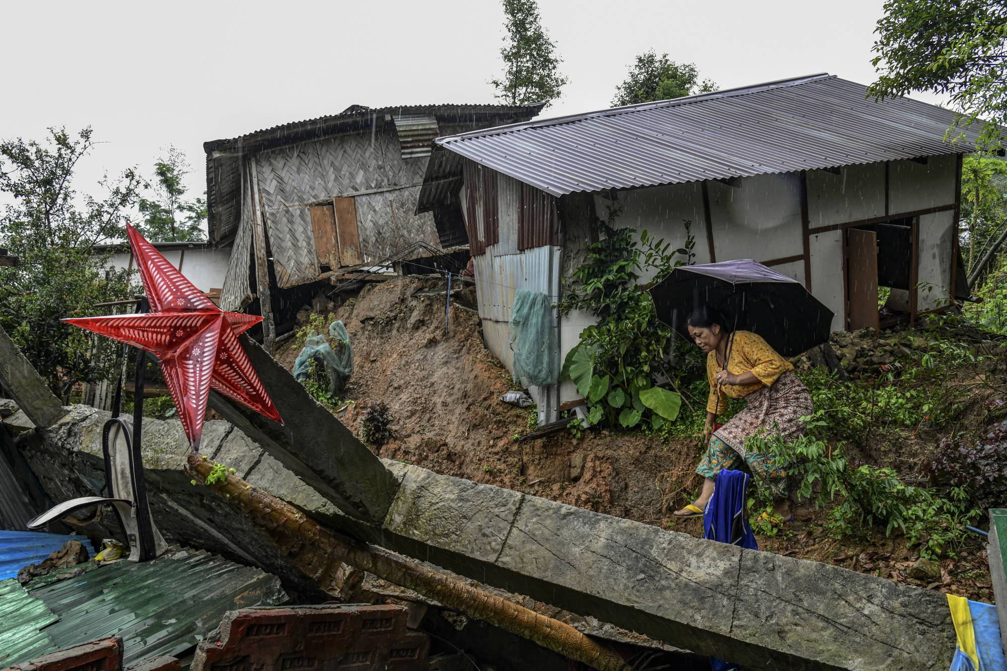 Houses damaged by a landslide in Dima Hasao, India, on June 3. | Atul Loke / The New York Times