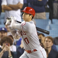 The Angels\' Shohei Ohtani triples against the Dodgers in the top of the ninth at Dodger Stadium on Wednesday. | KYODO