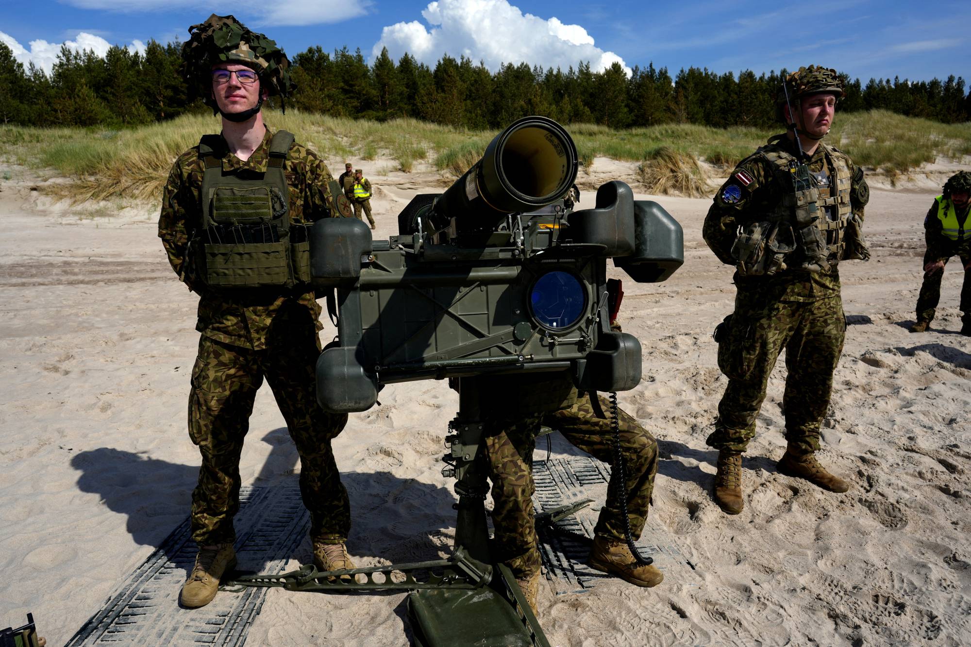 Latvian servicemen train with a short-range air defense system in Jurmalciems, Latvia, on June 9. | REUTERS 