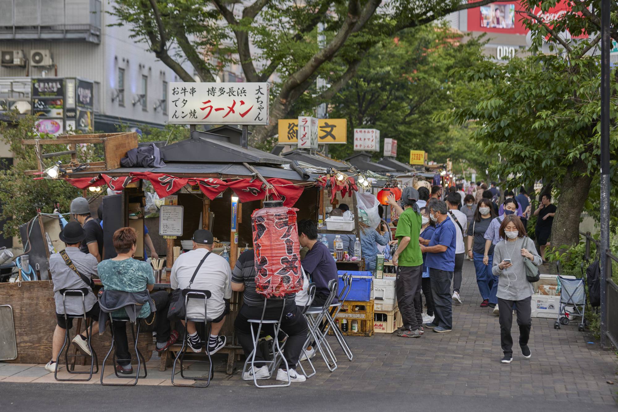 Customers eat at a mobile food stall, in the Nakasu area of Fukuoka on May 28. | BLOOMBERG