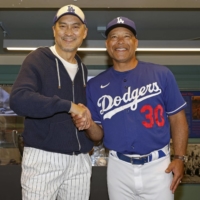 Actor Ken Watanabe poses with Dodgers manager Dave Roberts at Dodger Stadium in Los Angeles on Wednesday. | KYODO