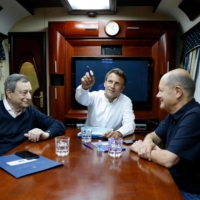 Italian Prime Minister Mario Draghi (left to right), French President Emmanuel Macron and German Chancellor Olaf Scholz travel on board a train bound for Kyiv on Thursday.  | POOL / VIA AFP-JIJI