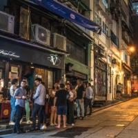 Customers outside a bar at the Lan Kwai Fong nightlife area in Hong Kong on Thursday.  | BLOOMBERG